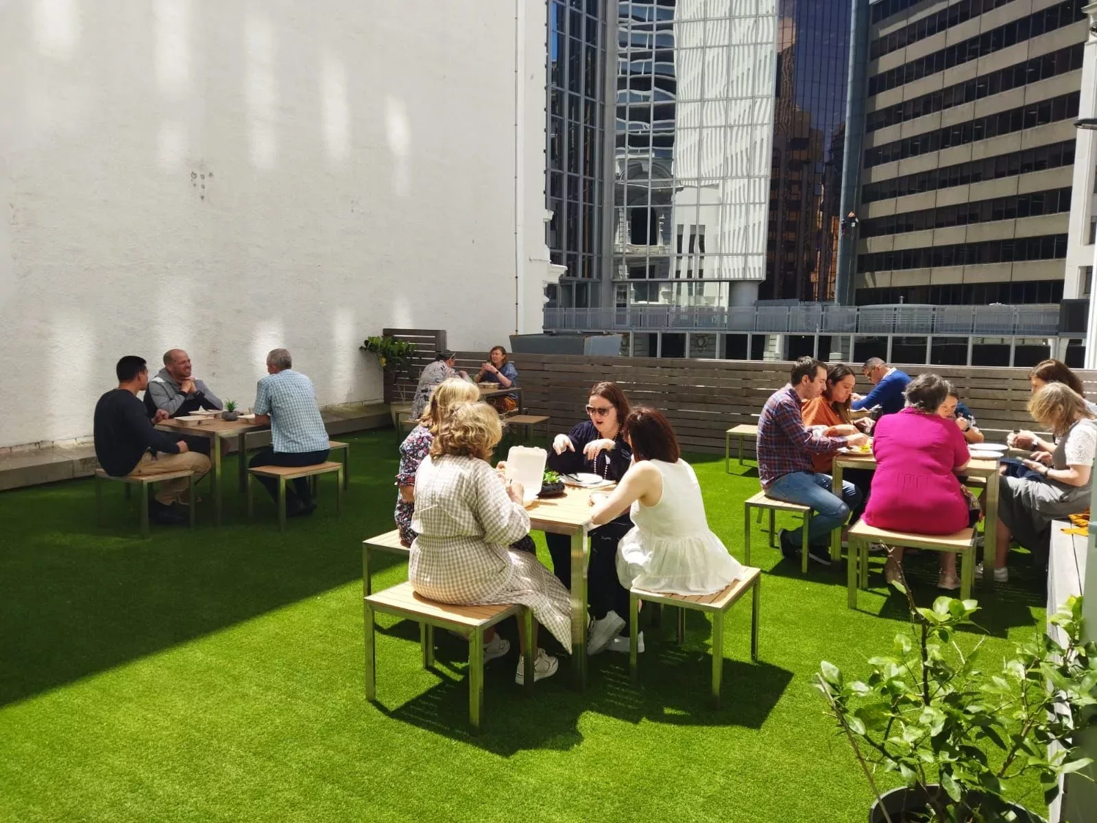 Office workers networking in Urban Hub's outdoor area