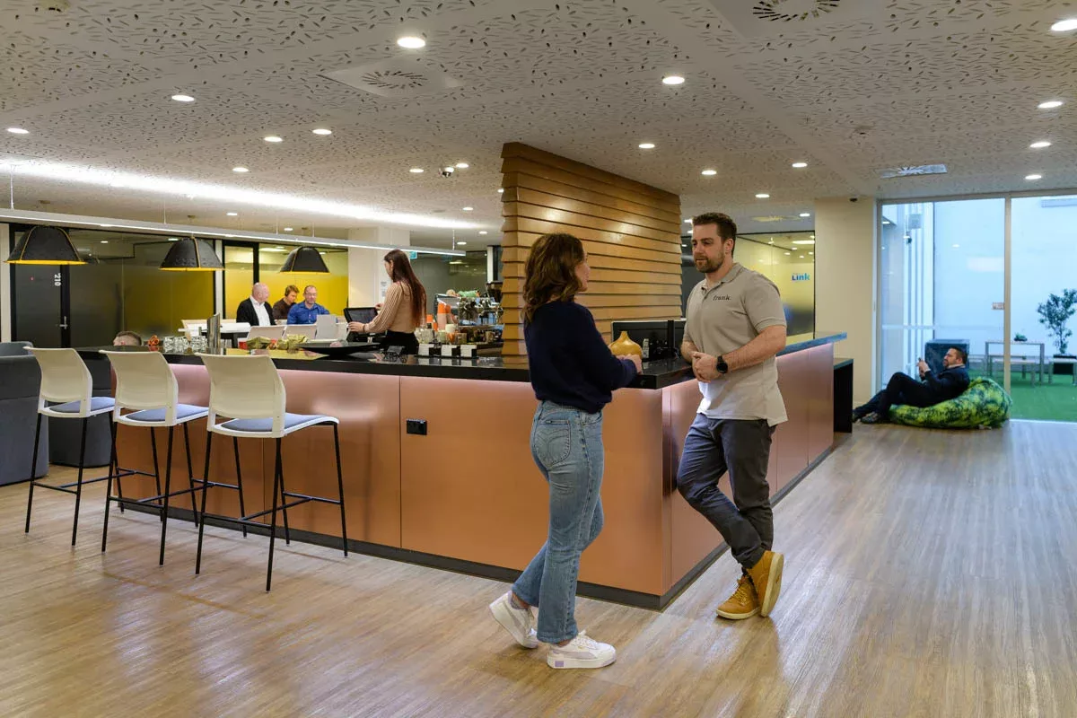 Co-workers socialising in Urban Hub's coffee area