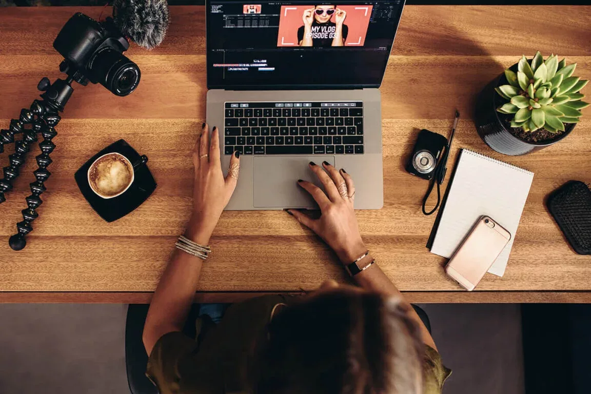 Woman with blogging business edits video on laptop