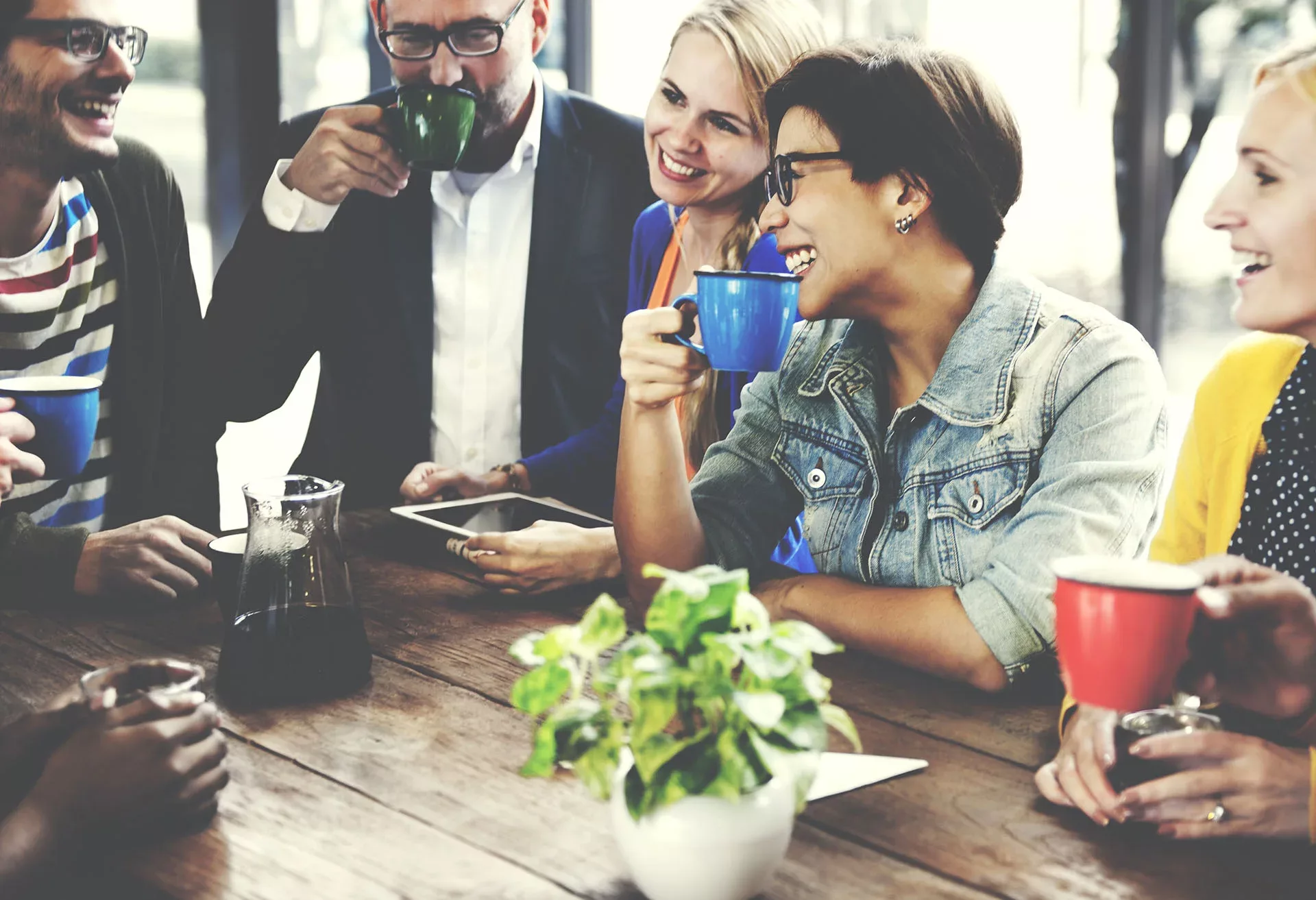 Smiling office workers enjoy coffee together