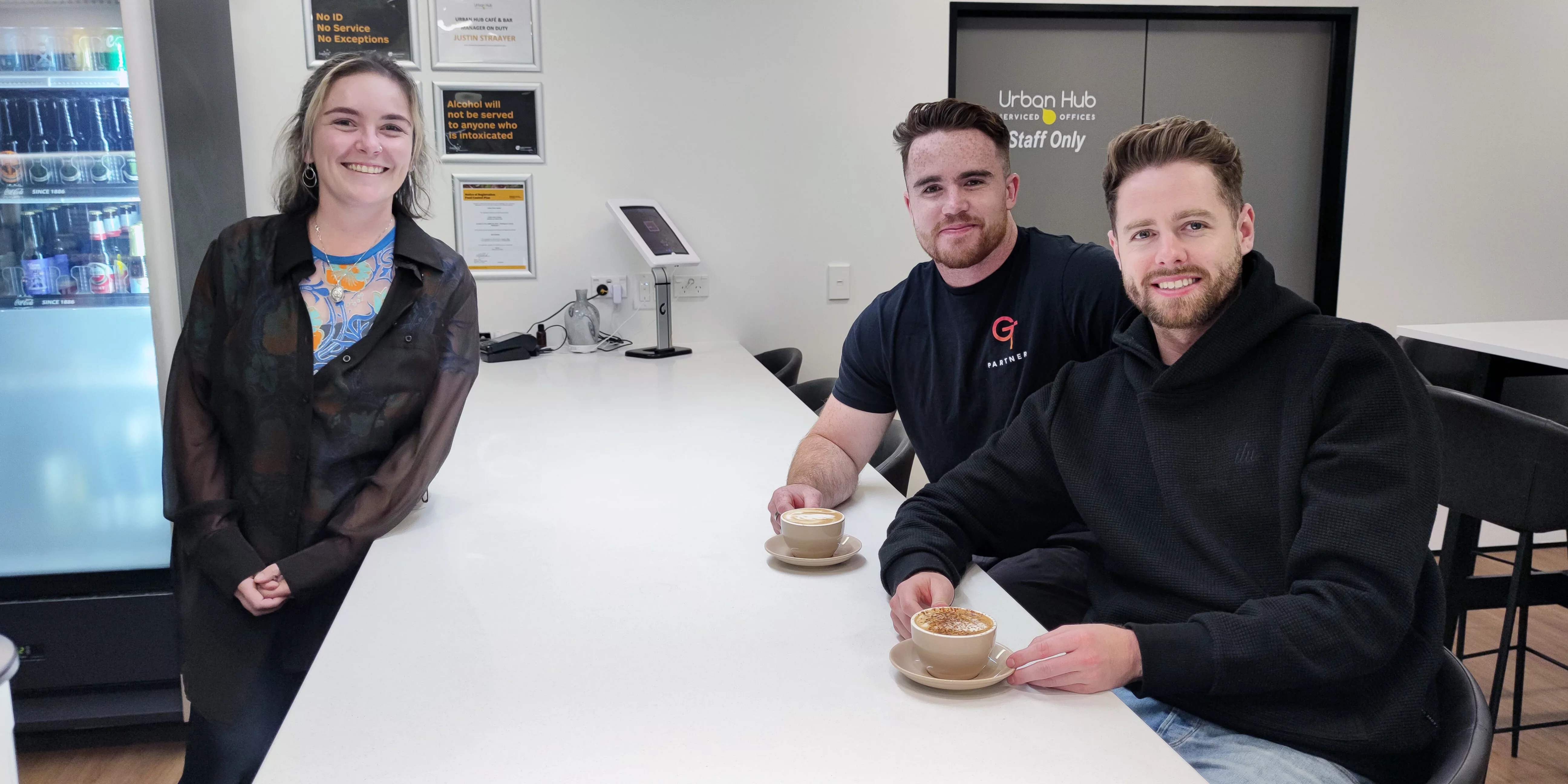 Staff from GEPS smile and drink coffee