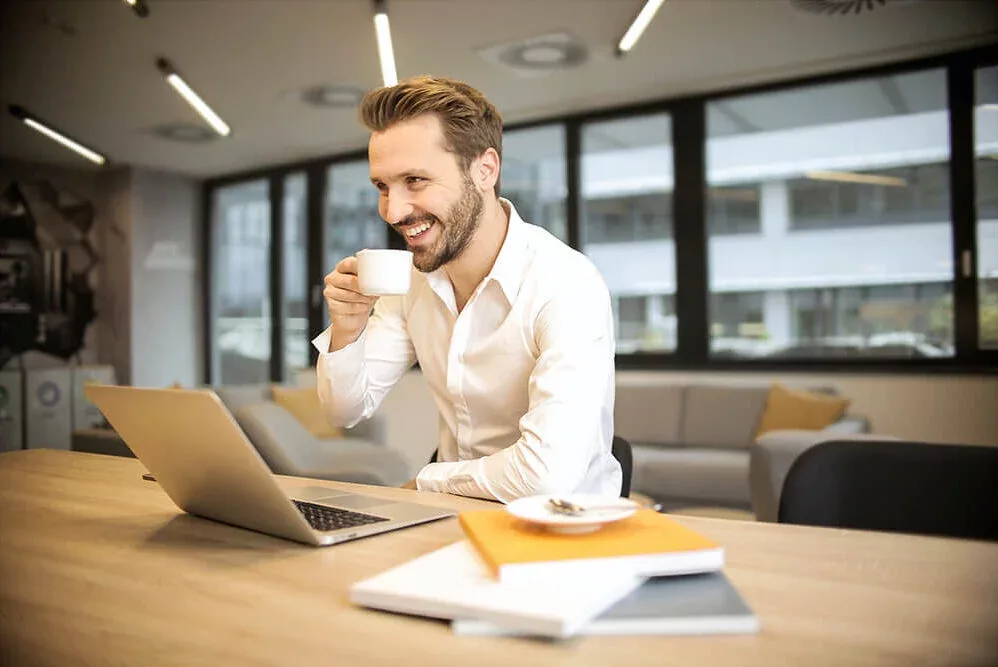 Man works on laptop from office desk