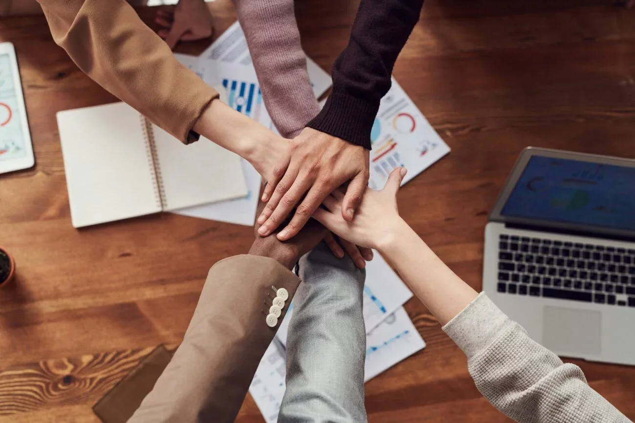 Diverse office person hands celebrating