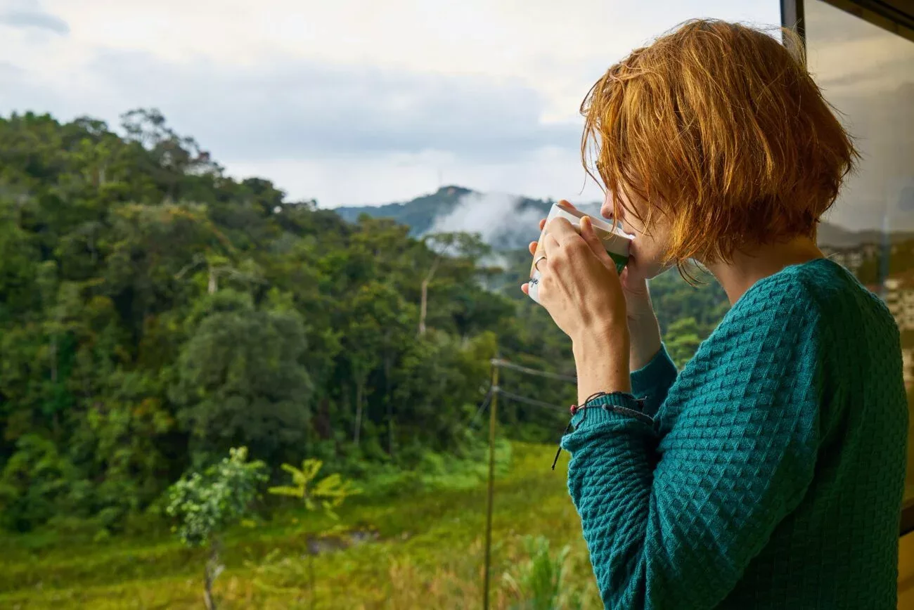 Woman drinking coffee outside in nature